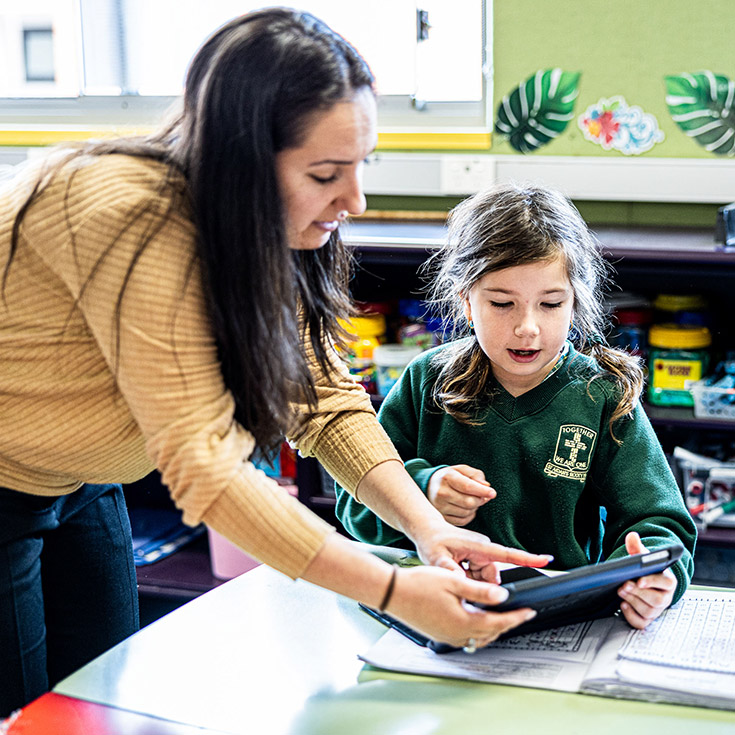 Teacher helping student at St Aidan's Catholic Primary Rooty Hill